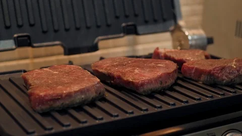 Grilled raw beef steak with smoke Stock Footage 120148642