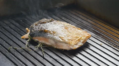 Grilled red fish steak salmon on the grill in slow motion Stock Footage 65120914