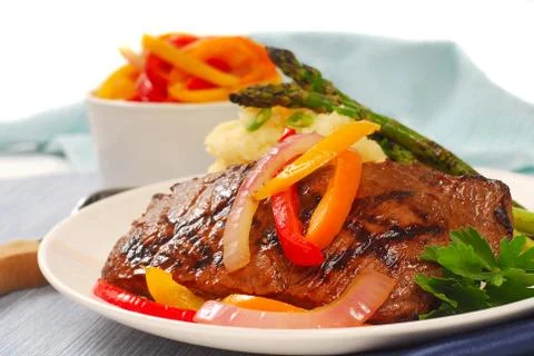 Grilled rib-eye steak with mashed potatoes Stock Photos