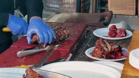 Grilled ribs cutting. Chef cuts barbecued ribs with knife. Stock Footage 279554485
