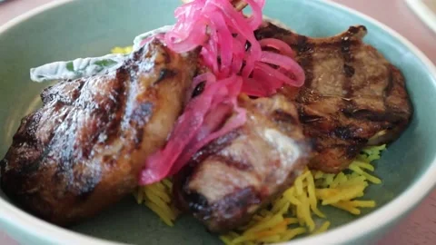 Grilled roasted lamb shank dish with garnish Stock Footage 228408280