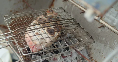 Grilled ruby ​​fish with salt.Grilled ruby ​​fish with salt is a food that Thai  Stock Footage 281009629
