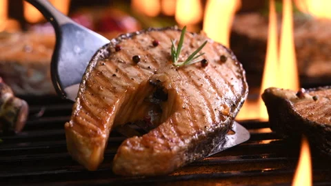 Grilled salmon fish with various vegetables on the flaming grill Stockbeeldmateriaal 146826986