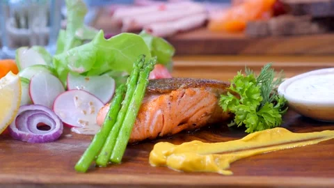 Grilled salmon with mixed vegetables on a plate, a perfect dish for a healthy Stock Footage 241328530