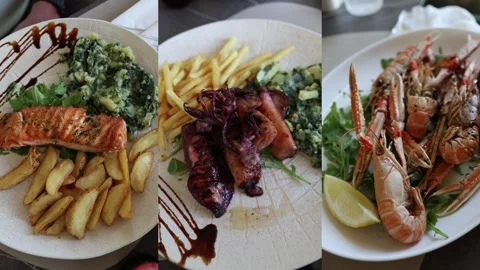 Grilled salmon squid and langoustines served as fresh restaurant seafood dishes Stock Footage 341558723