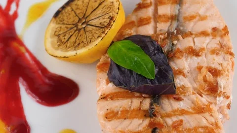 Grilled salmon steak, served in Restaurant Stock Footage 79713725