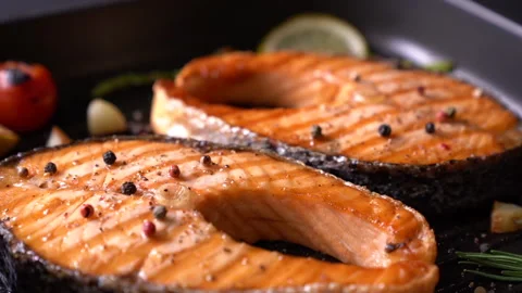 Grilled salmon steak with various vegetables on pan Stock Footage 145186319