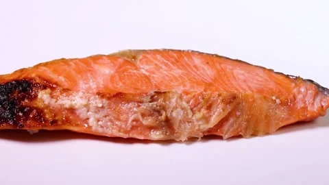 Grilled salmon on white background close up, rotating Video stock 309429549