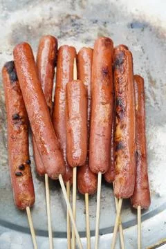 Grilled sausage on a copper plate ready to eat Stock Photos