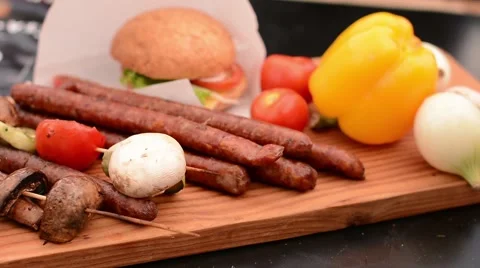 Grilled sausage with fresh vegetables and hamburger Stock Footage 59086235