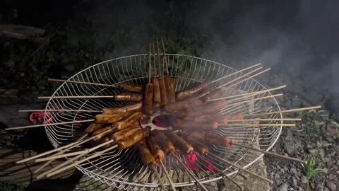 Grilled sausages using a traditional fire pit Stock Footage 296729567