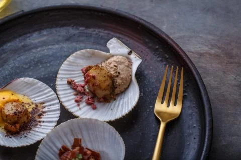 Grilled scallops shell with puree, close view, restaurant dish Stock Photos