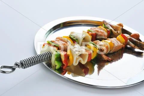 Grilled seafood and vegetable kebabs Stock Photos