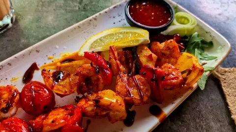 Grilled seafood topped with sauce, appetizing edibles in fancy plating Stock Footage 331921641
