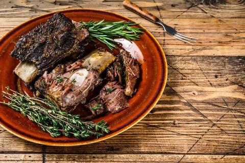 Grilled short beef ribs with thyme on a rustic plate. wooden background. Top Stock Photos