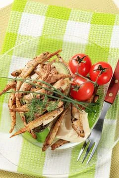 Grilled shrimp with cherry tomatoes on green cloth Stock Photos