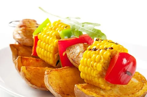 Grilled skewer with corn, pepper, and potato wedges Fotos de archivo