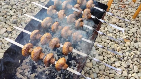 Grilled skewered mushrooms cooked over charcoal are a fantastic addition to 스톡 동영상 280307828