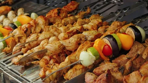 Grilled skewers of marinated chicken and colorful vegetables, including Stock Footage 344631908