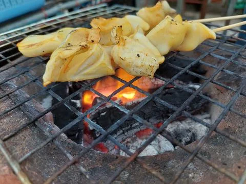 Grilled squid or octopus at Thai seafood market Stock Photos