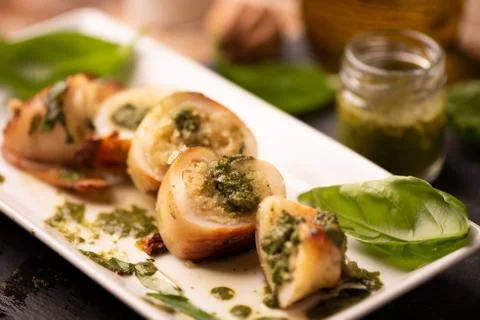 Grilled squid stuffed with basil closeup. Stock Photos