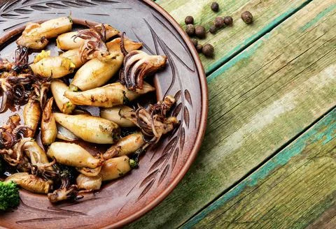 Grilled squids in plate Stock Photos