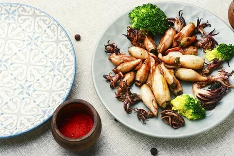 Grilled squids in plate Stock Photos