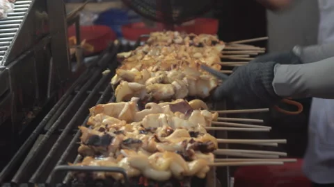 Grilled squids preparing for customer. Fresh squid in stick grill . Video stock 169311783