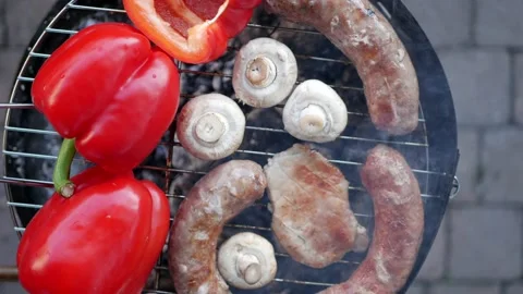 Grilled steak with aromatic spices and vegetables on the grill plate outdoors Stock Footage 138035853