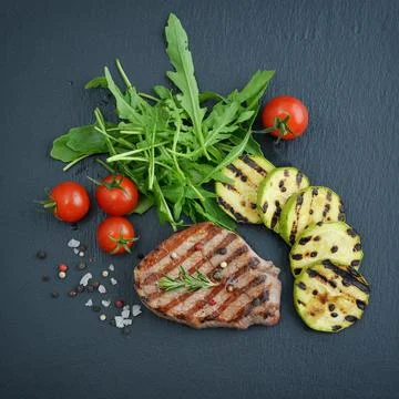 Grilled steak with arugula Stock Photos