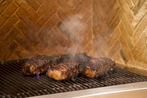 Grilled Steak with flames Stock Photos
