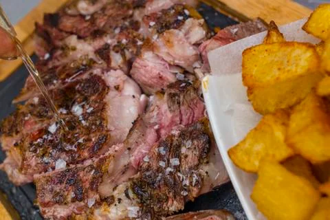 Grilled steak with fried potatoes Stock Photos