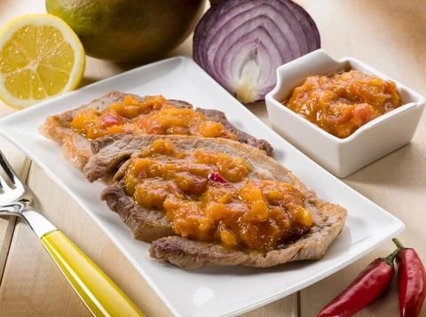 Grilled steak with mango sauce Stock Photos