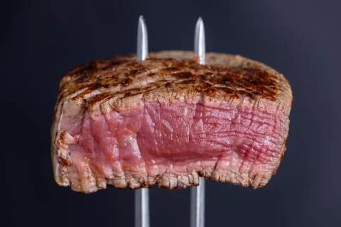 Grilled steak on a meat fork Stock Photos