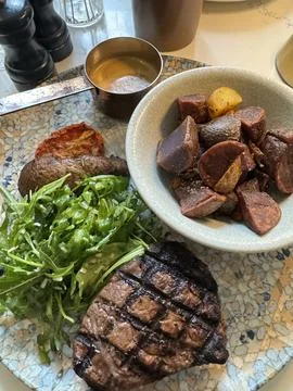 Grilled Steak with Roasted Potatoes and Arugula Salad Stock Photos