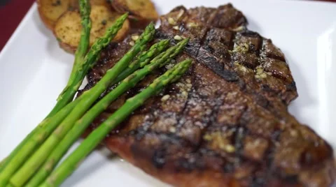 Grilled T-bone Steak with Potatoes and Asparagus Stock Footage 40215183