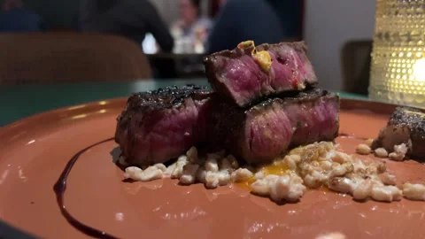 Grilled t-bone steak served on white plate in meat restaurant,filmed from above Stock Footage 302073875