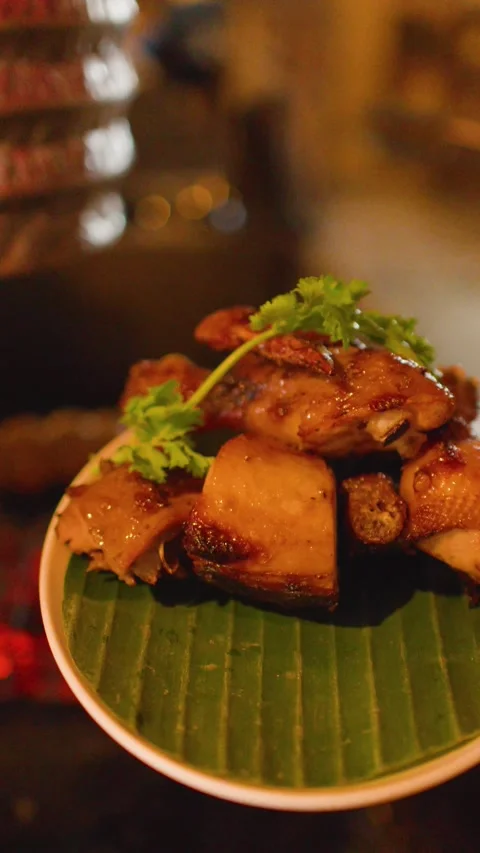 Grilled Thai Isan Chicken Served on Banana Leaf Plate Stock Footage 344948336
