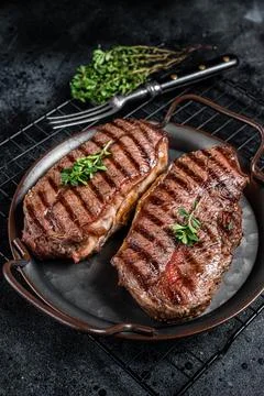 Grilled Top Blade or flat iron beef meat steaks. Black background. Top View Stock Photos