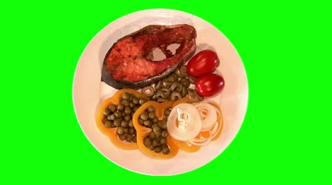 Grilled trout with raw vegetables on plate, top shot Stock Footage 47547510