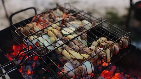 Grilled vegetables as a garnir to some meat dish. Grilling potatoes, mushrooms Stock Footage 132696476