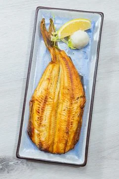 Grilled white fish fillet with lemon and daikon Foto stock