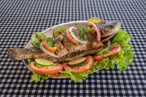 Grilled whole fish plate with fresh vegetables Stock Photos