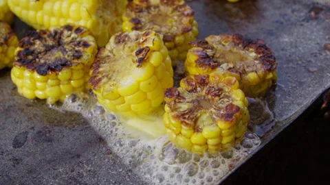 Grilled young corn in boiling butter. Slow motion Stock Footage 140202166