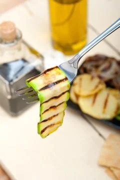 Grilled zucchini courgette on a fork Stock Photos