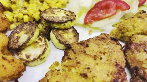 Grilled zucchini slices and crispy chicken cutlet on plate, close-up shot Stock Footage 345166387