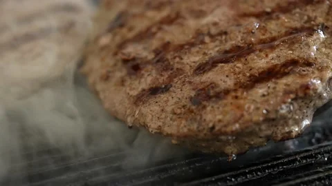 Grilling and flipping beef patty for hamburger Stock Footage 160567201