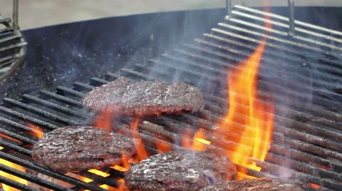 Grilling and flipping a burger with flames  Video stock 65676403