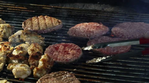Grilling and flipping a burger with flames Stock Footage 67968752