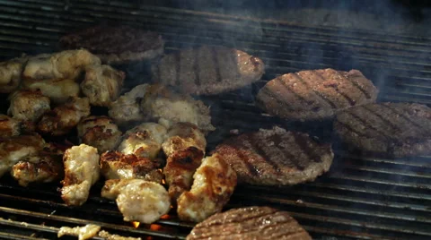 Grilling and flipping a burger with flames Stock Footage 67968776